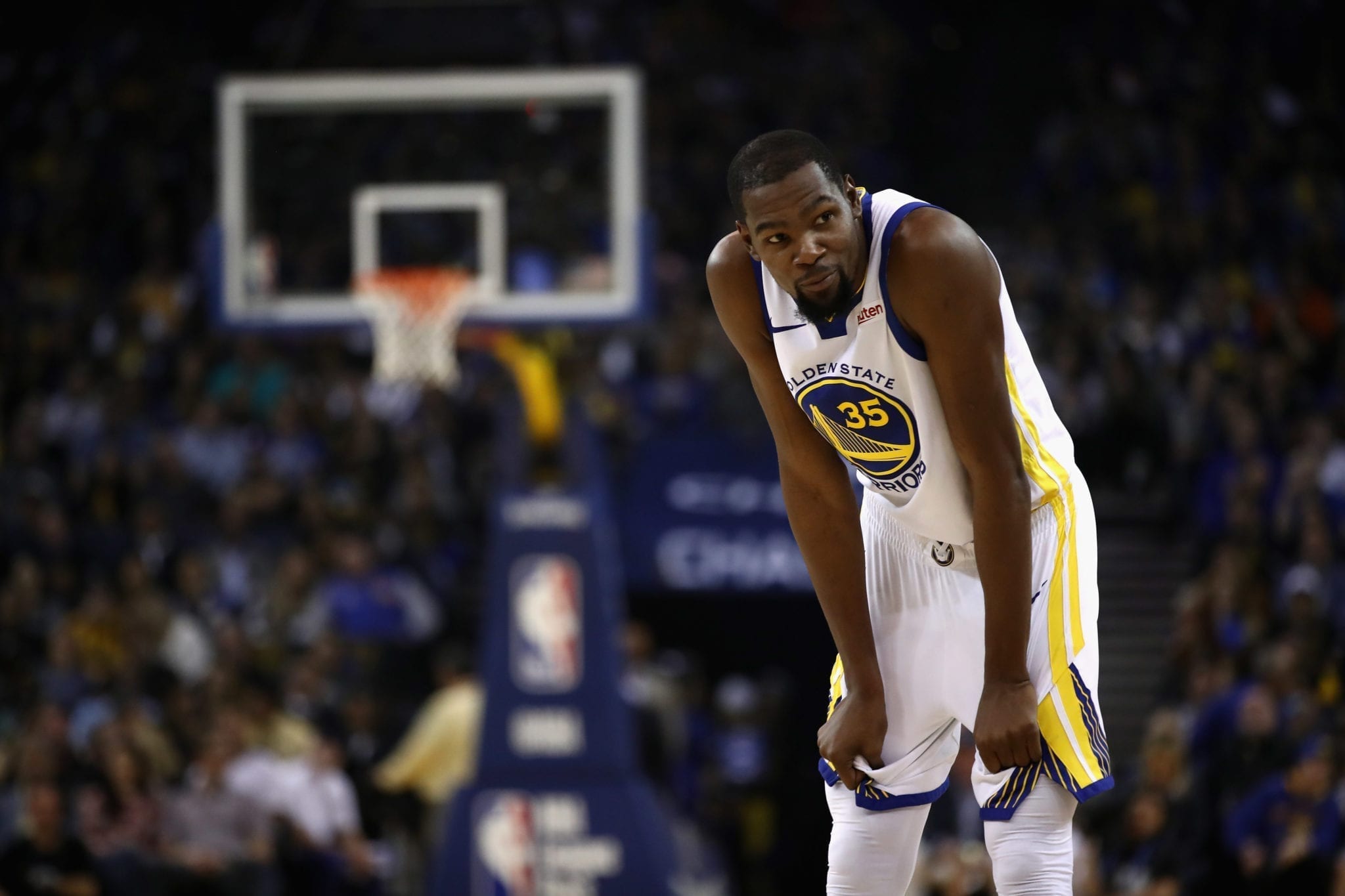 OAKLAND, CA - OCTOBER 16: Kevin Durant #35 of the Golden State Warriors smiles back towards the bench of the Oklahoma City Thunder at ORACLE Arena on October 16, 2018 in Oakland, California. NOTE TO USER: User expressly acknowledges and agrees that, by downloading and or using this photograph, User is consenting to the terms and conditions of the Getty Images License Agreement. (Photo by Ezra Shaw/Getty Images)