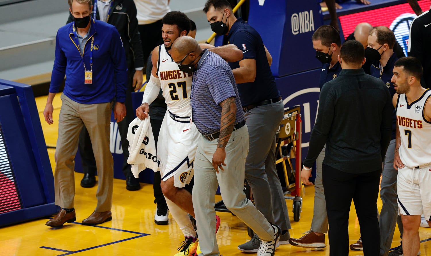 Nuggets star Jamal Murray being helped off the court