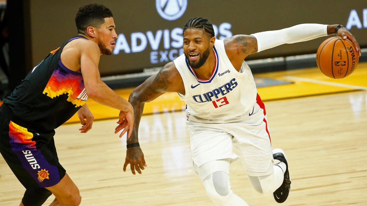 Clippers forward Paul George driving against the Suns Devin Booker