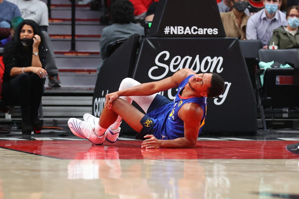Nuggets guard P.J. Dozier on the ground injured